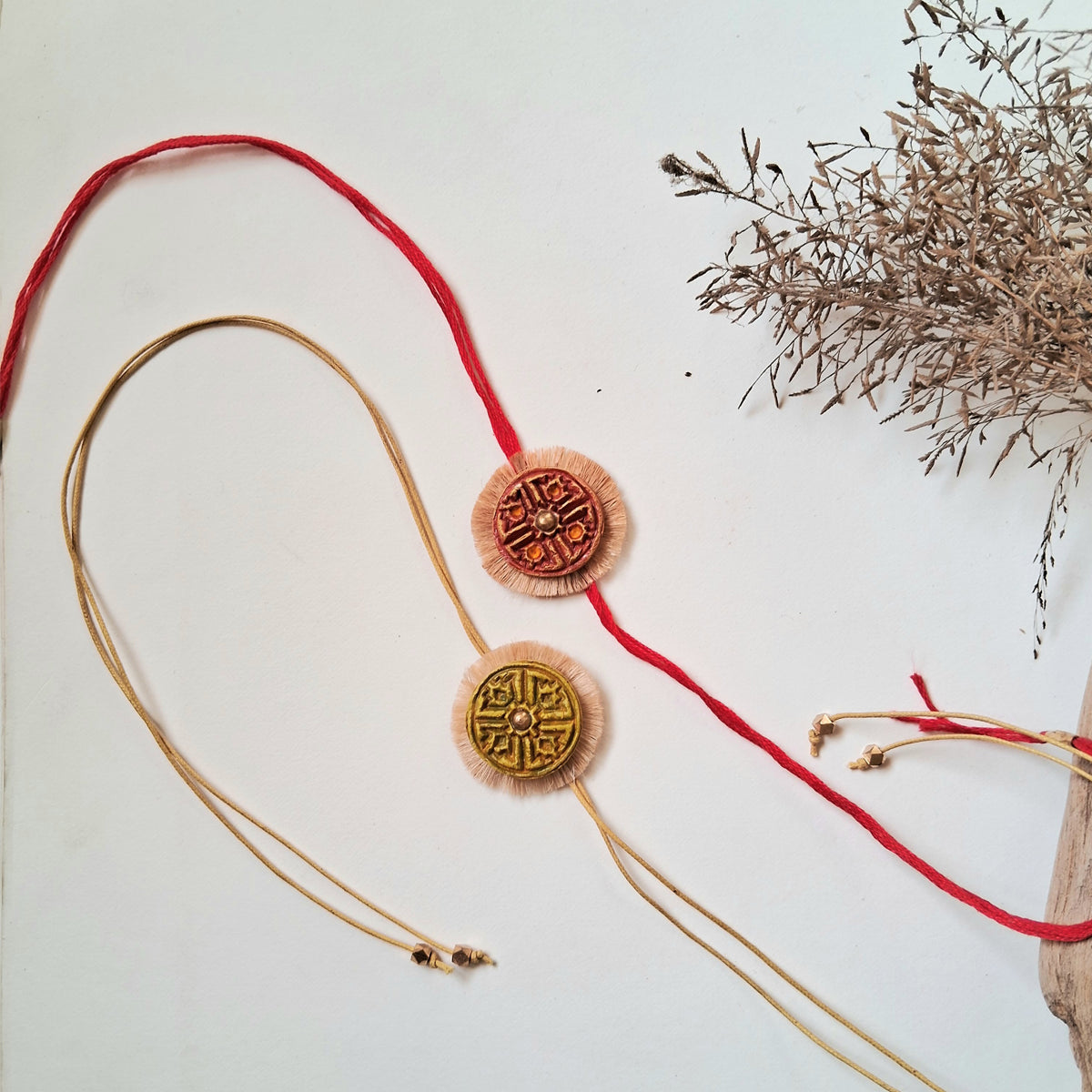 HAnd-made Papier-mache Twin Swastika Rakhi-Red & Yellow Ochre