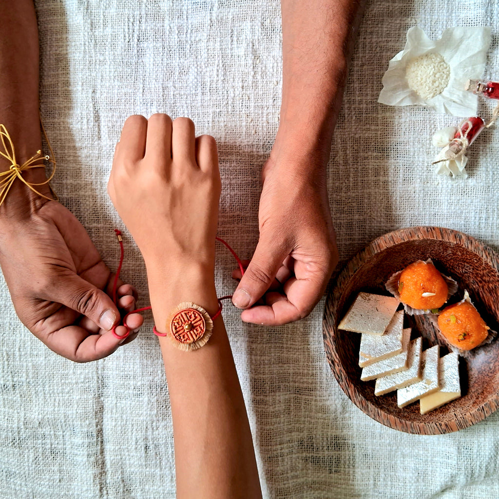 HAnd-made Papier-mache Twin Swastika Rakhi-Red & Yellow Ochre